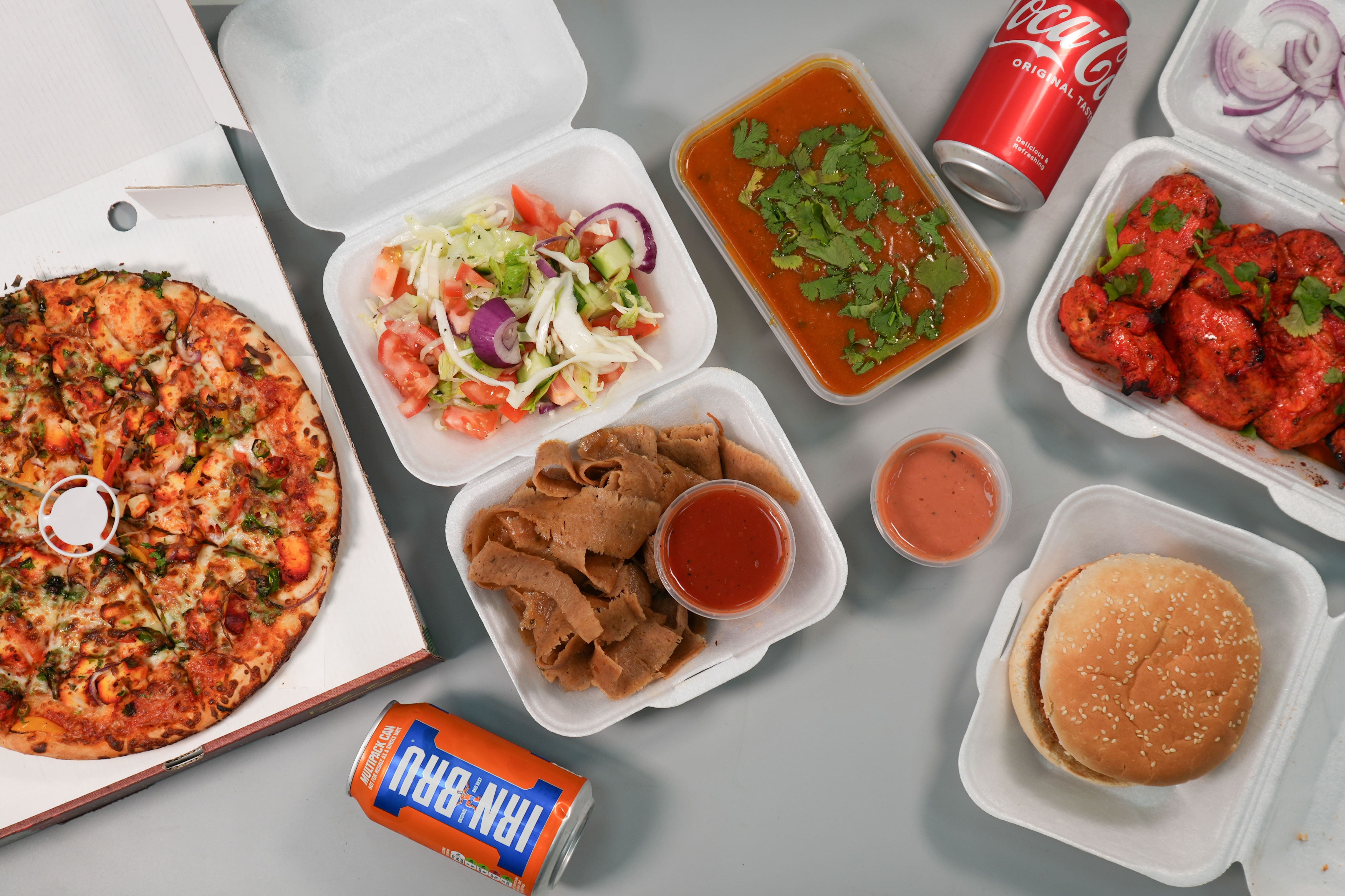 fresh pizza, grilled burger, sizzling tandoori chicken, doner kebab with salad all served at Paprikas Nicos Johnstone